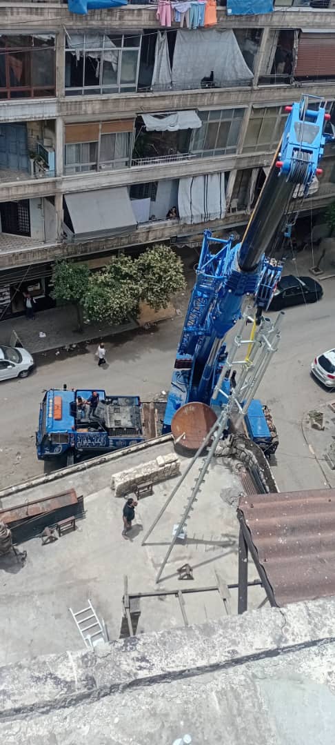 Crane lifting equipment to a rooftop site